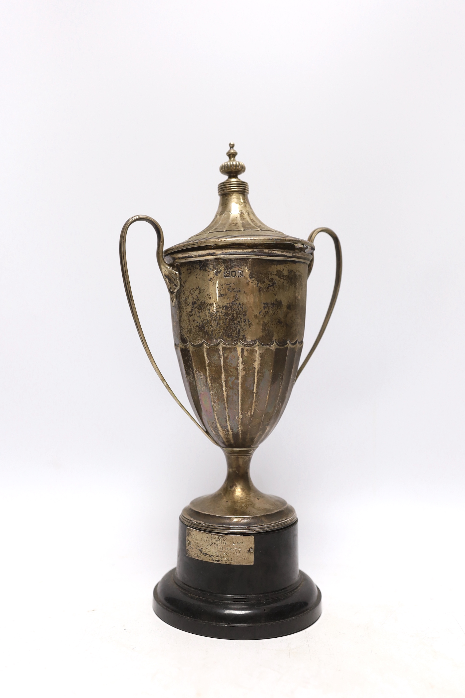 A George V silver two handled trophy cup and cover, London, 1910, on an ebonised base, cup height only, 24.5cm.